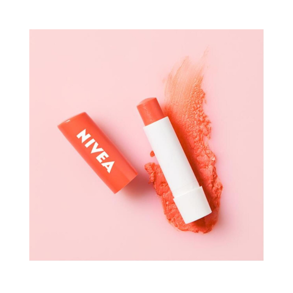 Four Nivea peach lip balms arranged in a neat line, highlighting their sleek, compact design.
