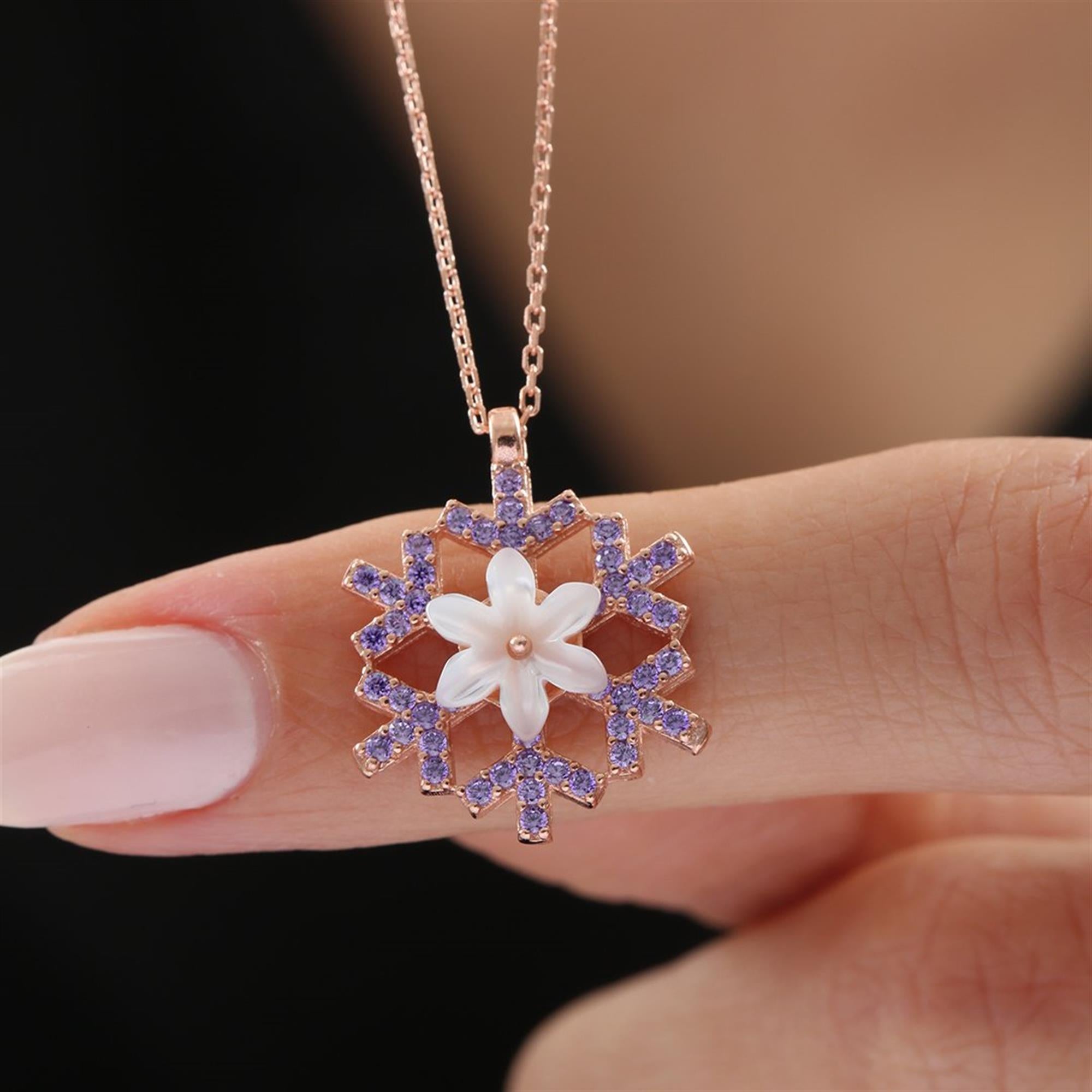 Rose gold amethyst snowflake necklace with white magnolia flower – a dreamy winter pendant with elegant purple sparkle