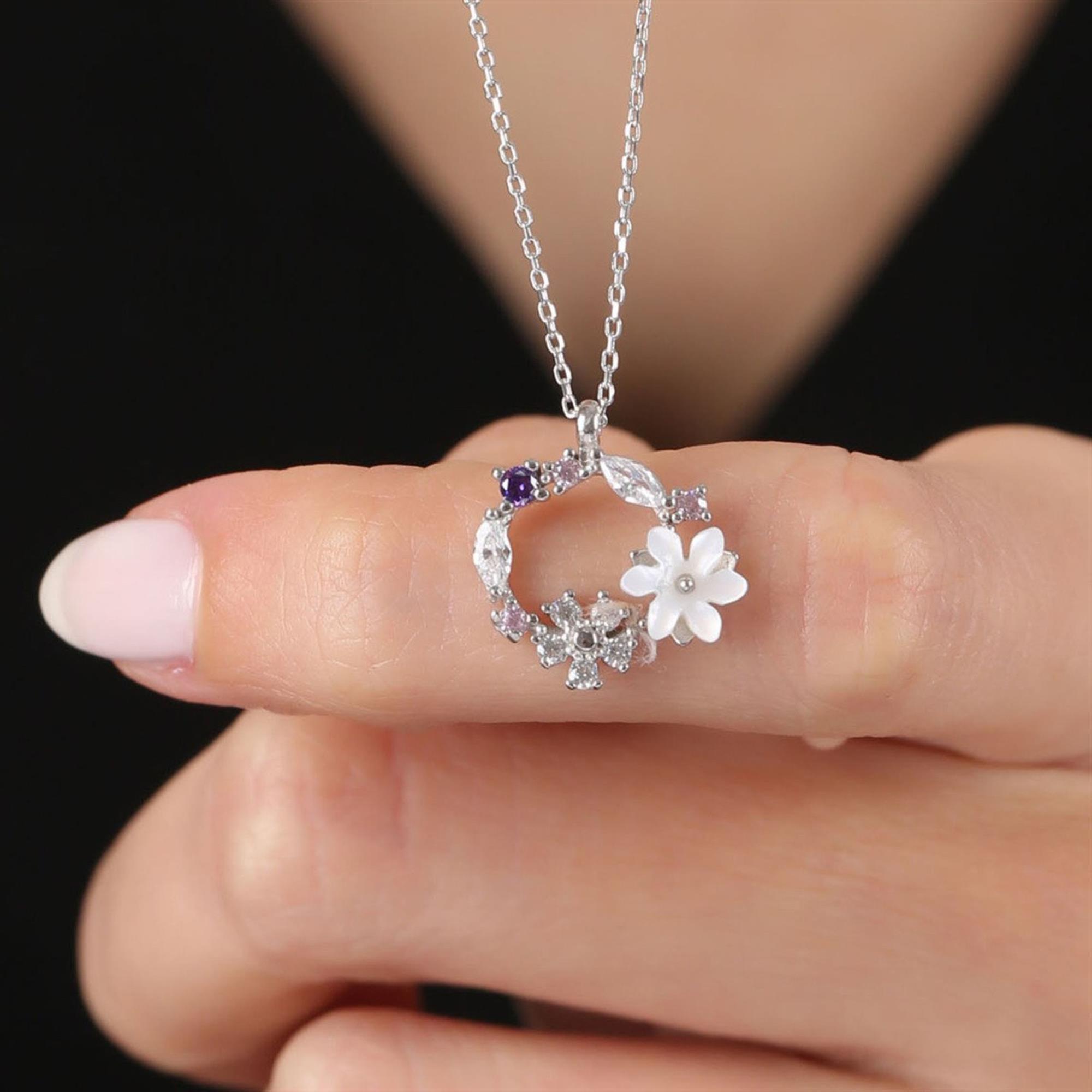 Silver circle necklace with white magnolia flower, sparkling leaves and floral zirconia accents