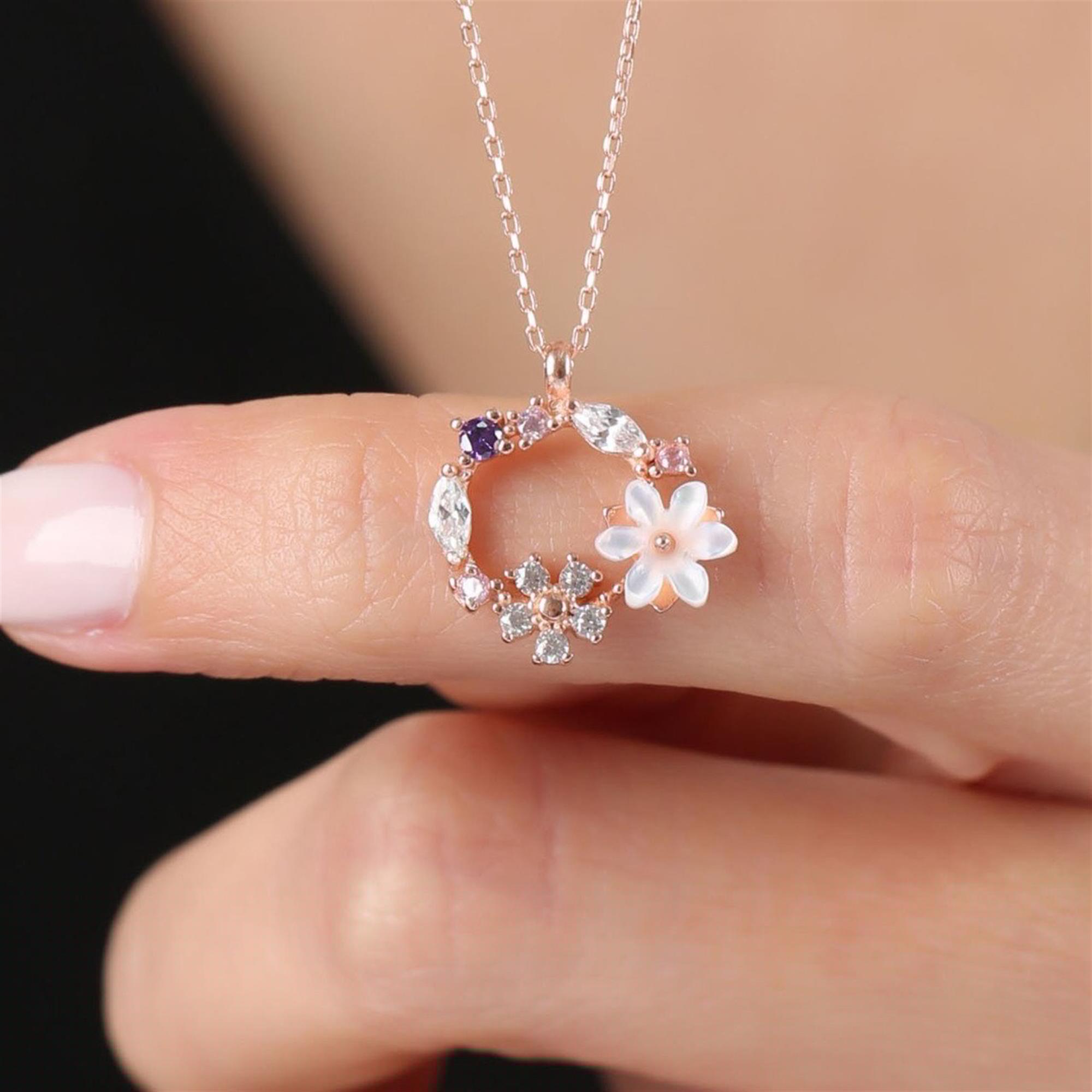 Rose gold floral wreath necklace with white mother-of-pearl magnolia and pastel gemstone accents