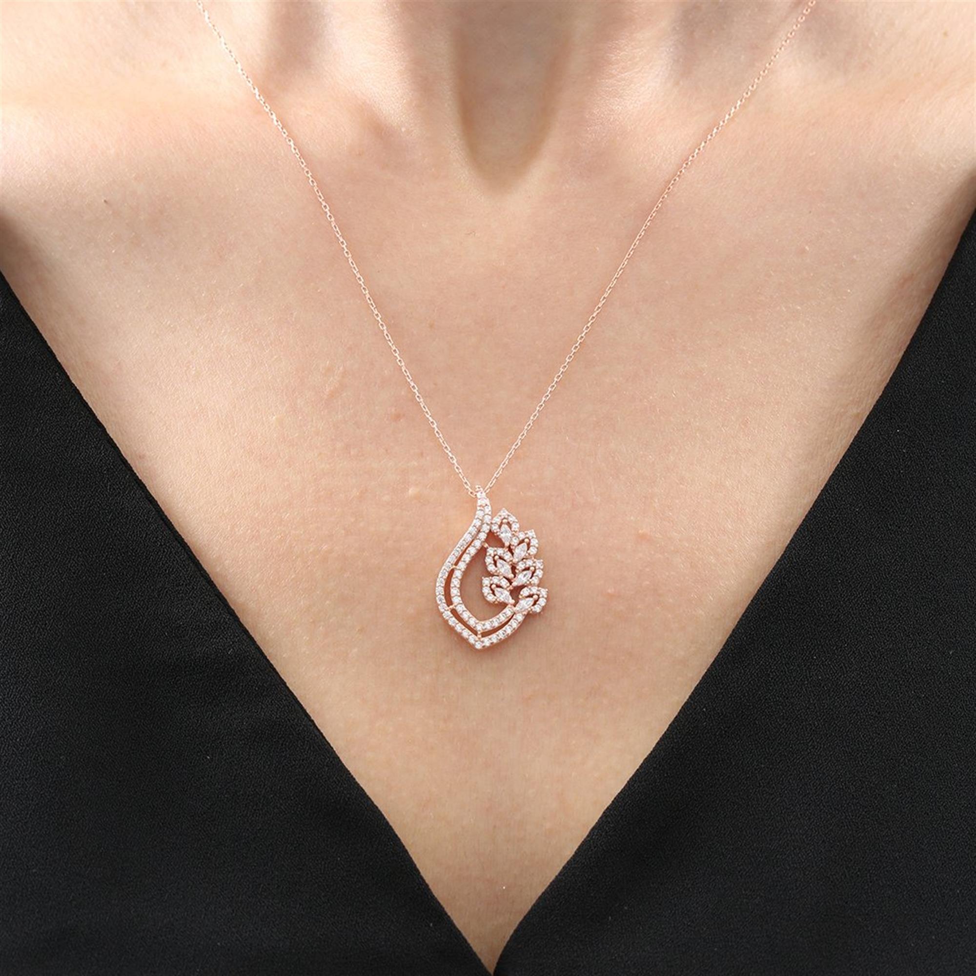 Rose gold teardrop necklace with crystal leaf accents and brilliant-cut stones