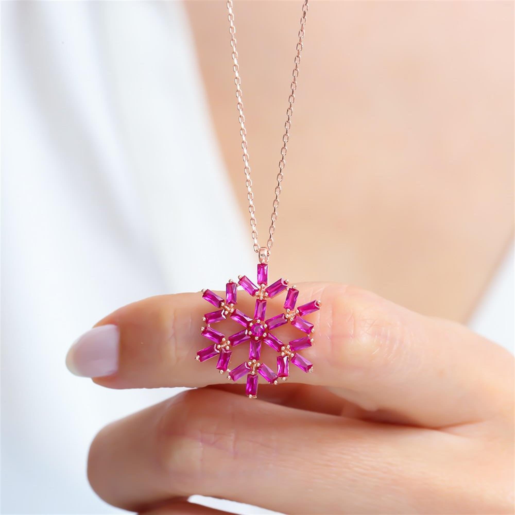 Fuchsia baguette stone snowflake pendant necklace in rose gold – a dazzling geometric winter charm piece made of sterling silver.