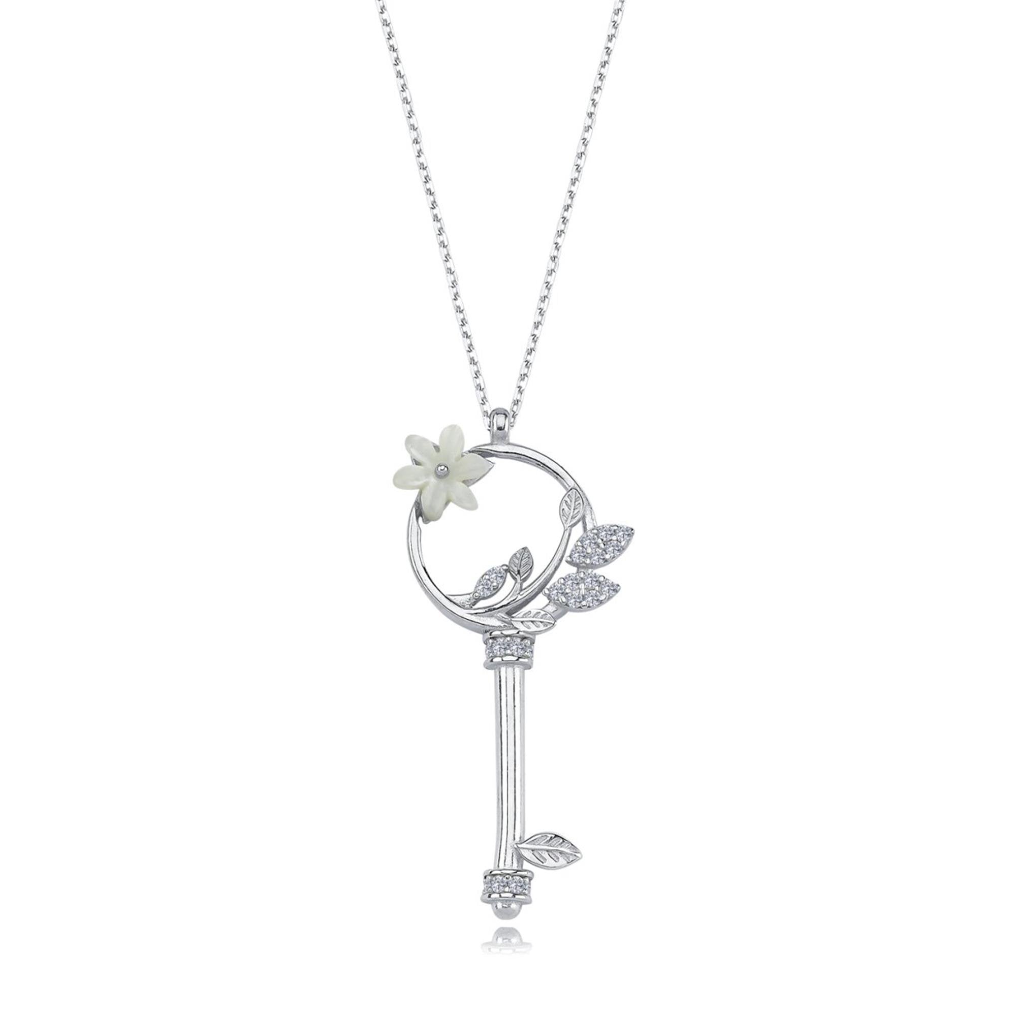 Sterling silver key-shaped necklace with white magnolia flower and sparkling leaf details