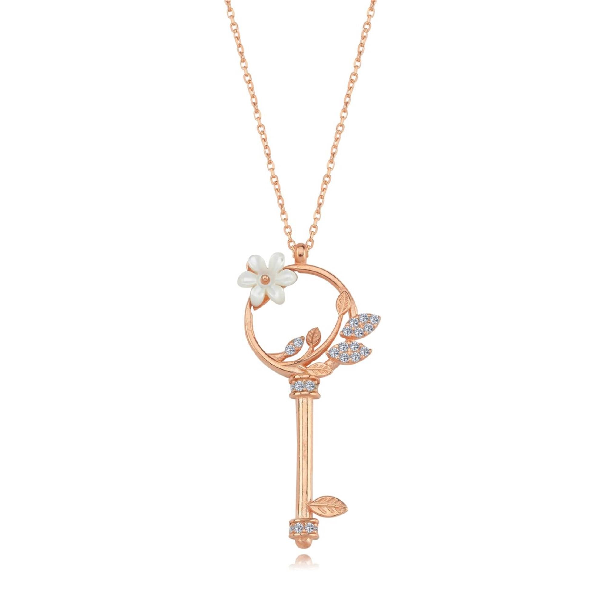 Collar de llave en oro rosa con flor de magnolia de nácar y hojas de circonita – joya simbólica y floral para momentos especiales
