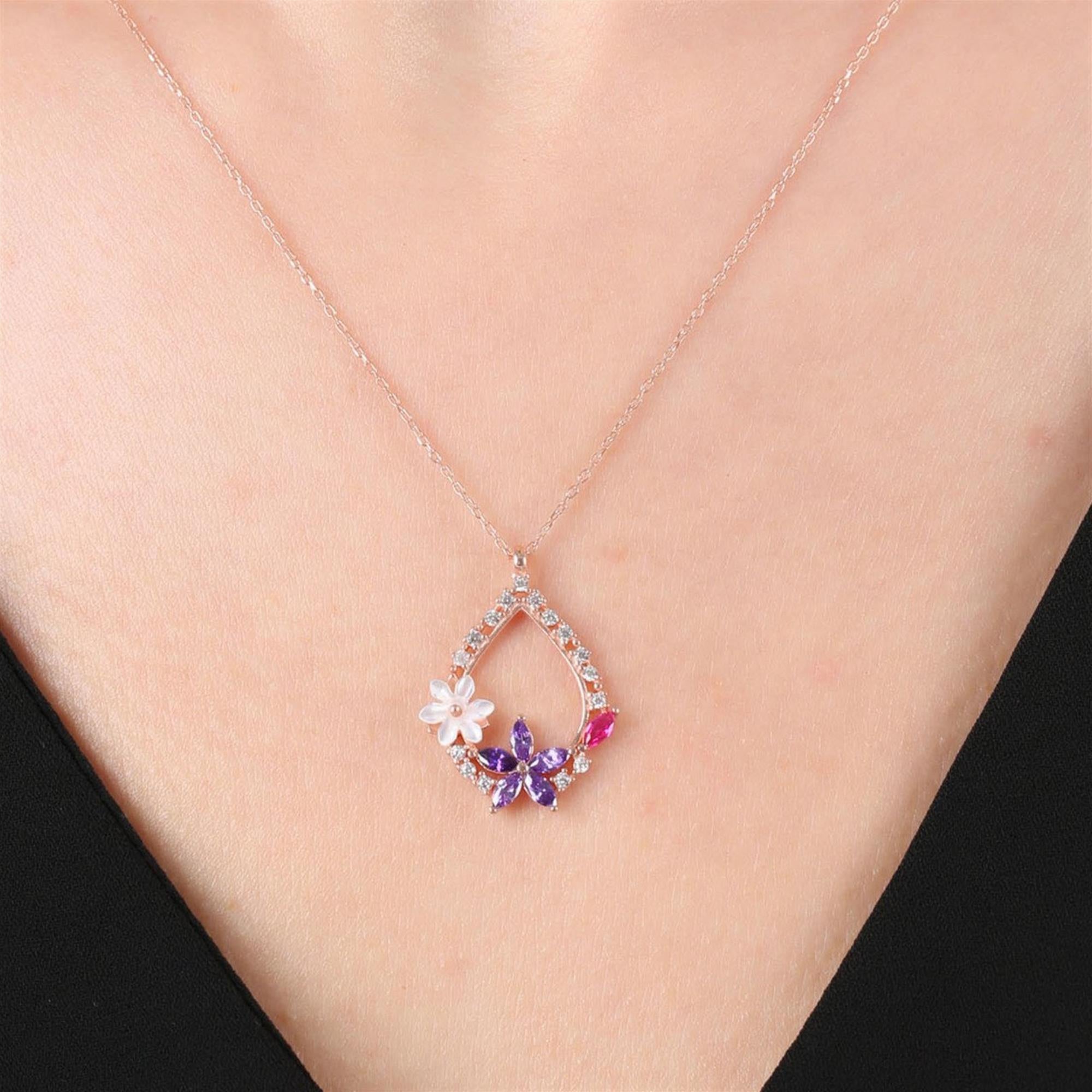 Rose gold teardrop necklace with amethyst and white flower design, accented by pink marquise stone