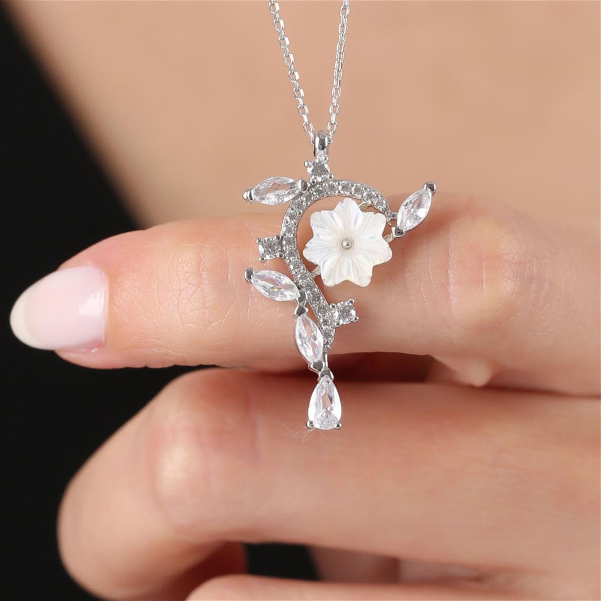 Silver-tone floral necklace with white magnolia, marquise CZ leaves and crystal drop – asymmetric elegant pendant for women