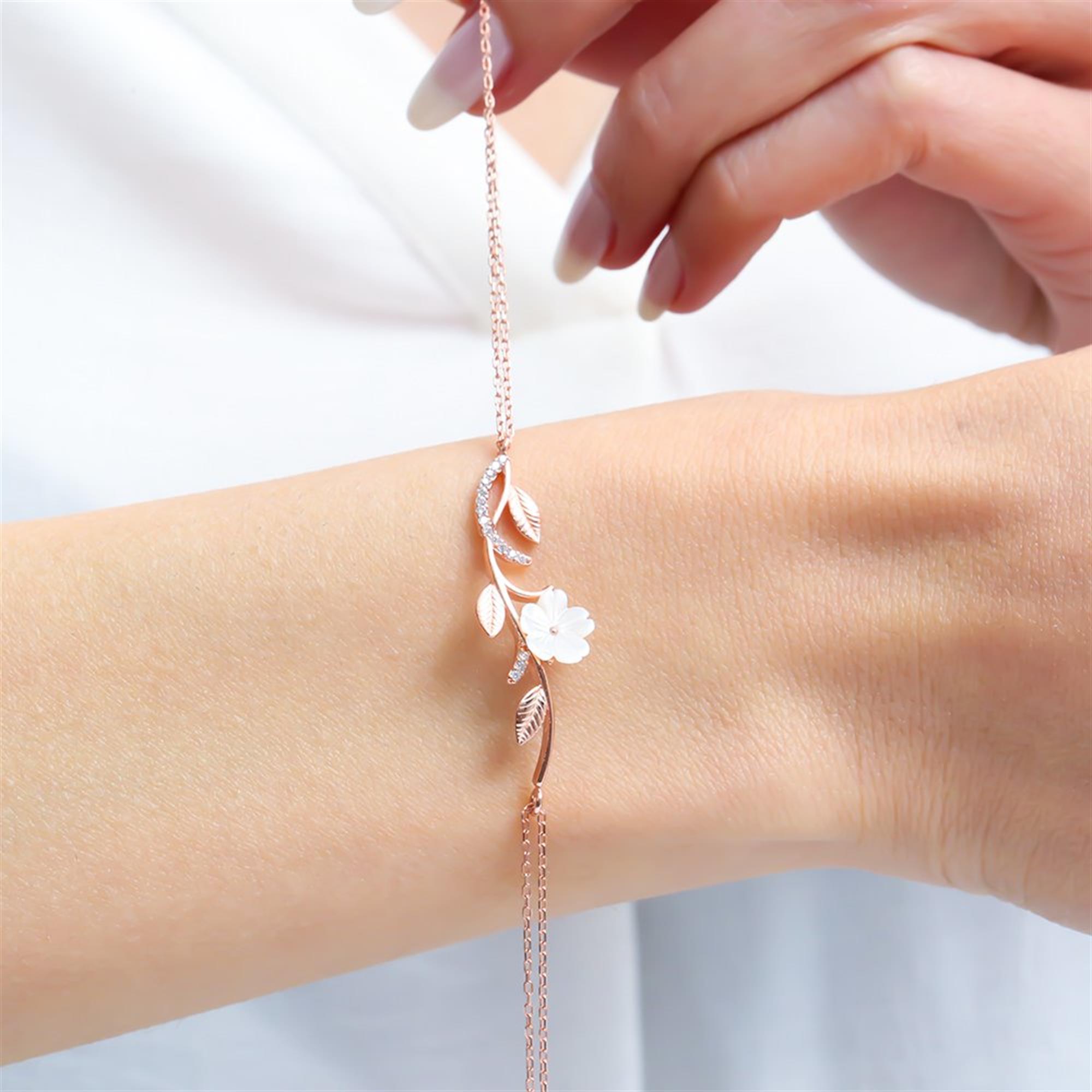 Delicate rose gold magnolia bracelet with pearl flower and sparkling zircon leaves, perfect for romantic and daily wear.