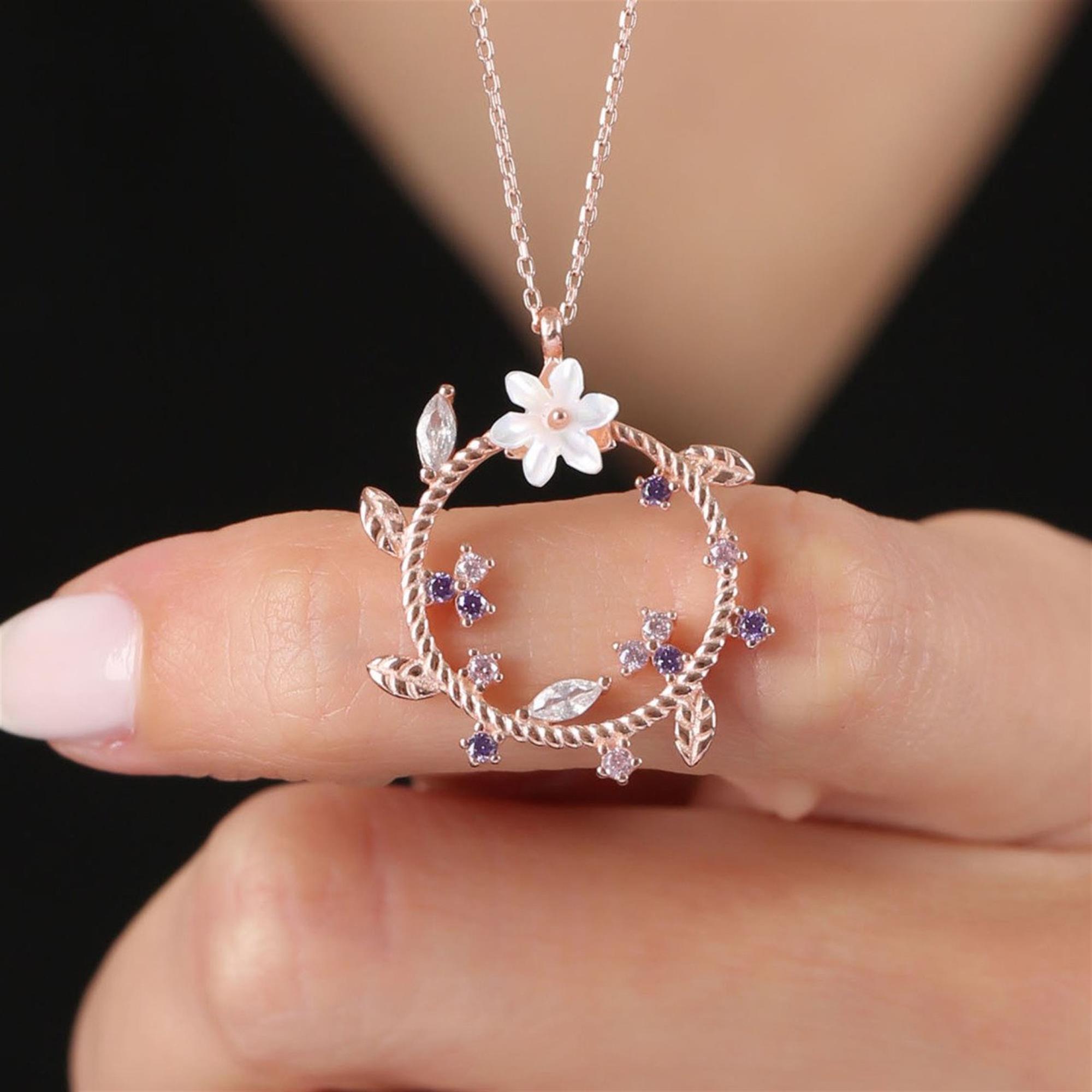 Rose gold twisted circle necklace with white magnolia flower, purple and pink gemstone accents