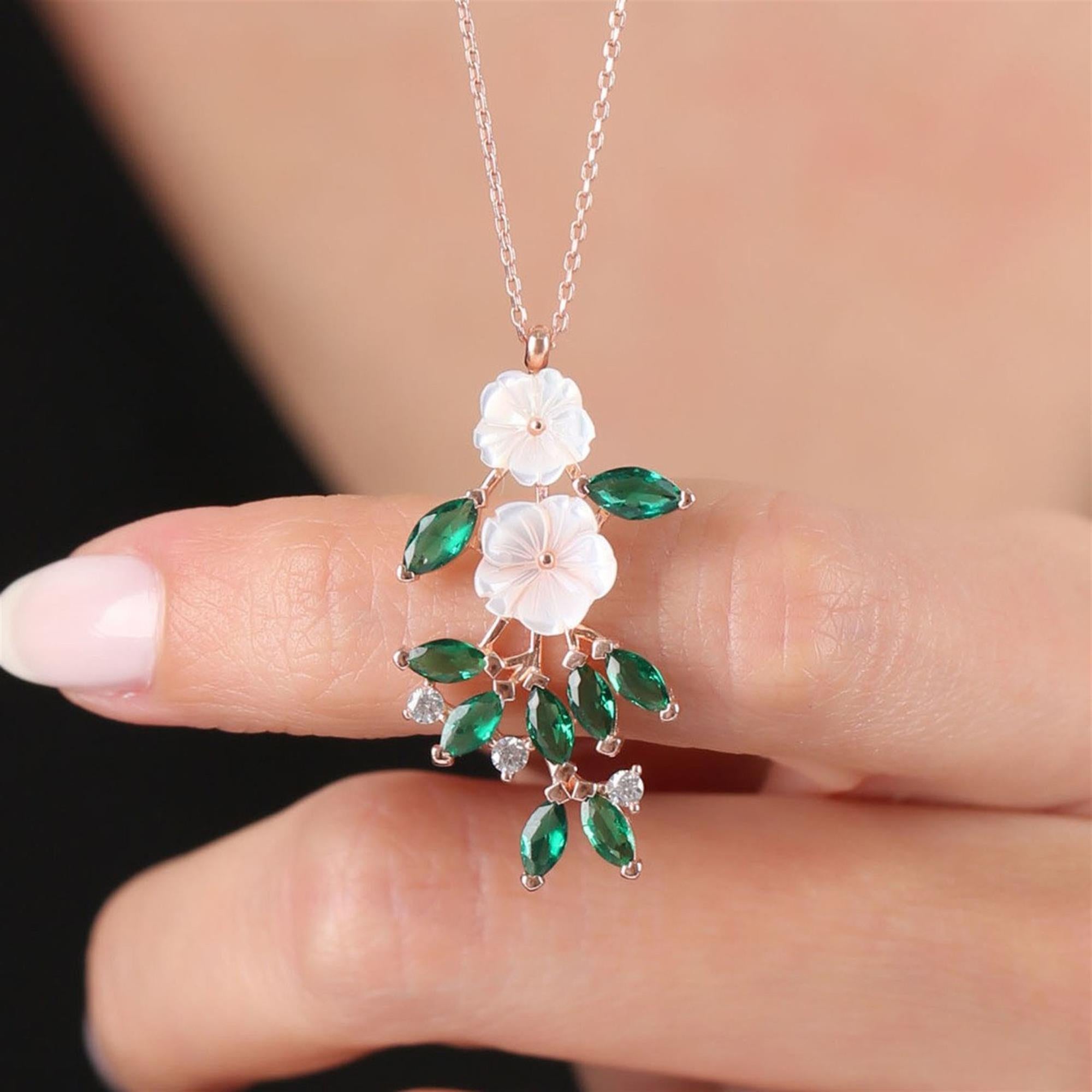 Rose gold drop necklace with emerald green CZ stones and white magnolia flowers – floral pendant for women