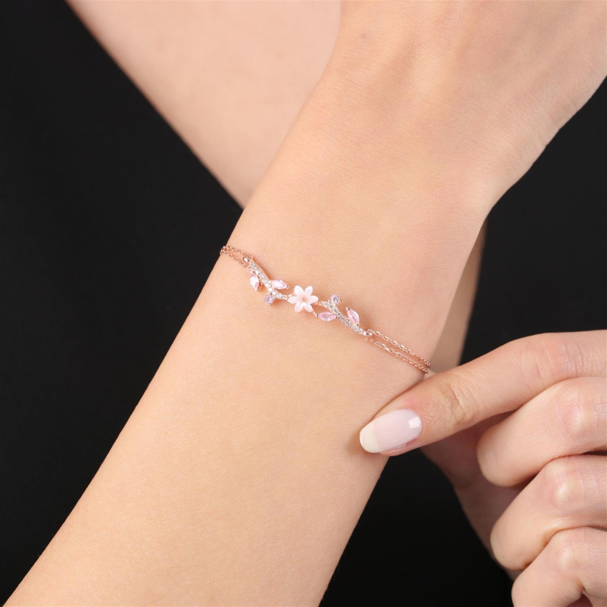 Rose gold bracelet with pink mother-of-pearl magnolia flower and leaf-shaped stones