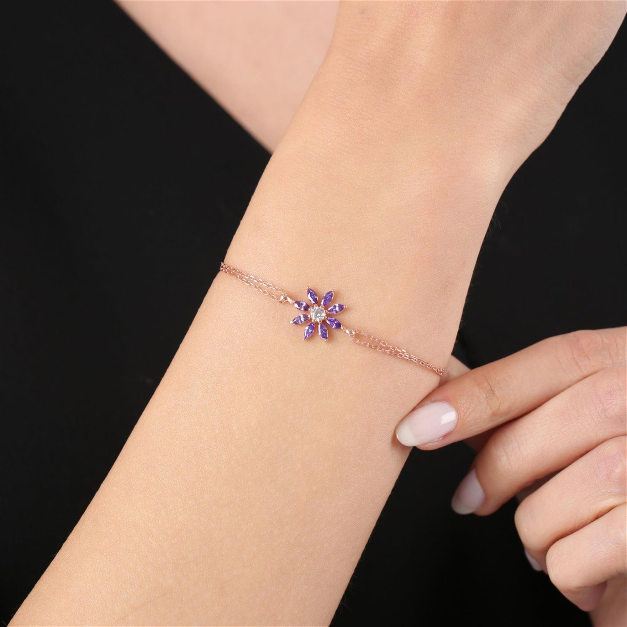 Rose gold bracelet with purple marquise stones forming a sun-like flower on a double chain