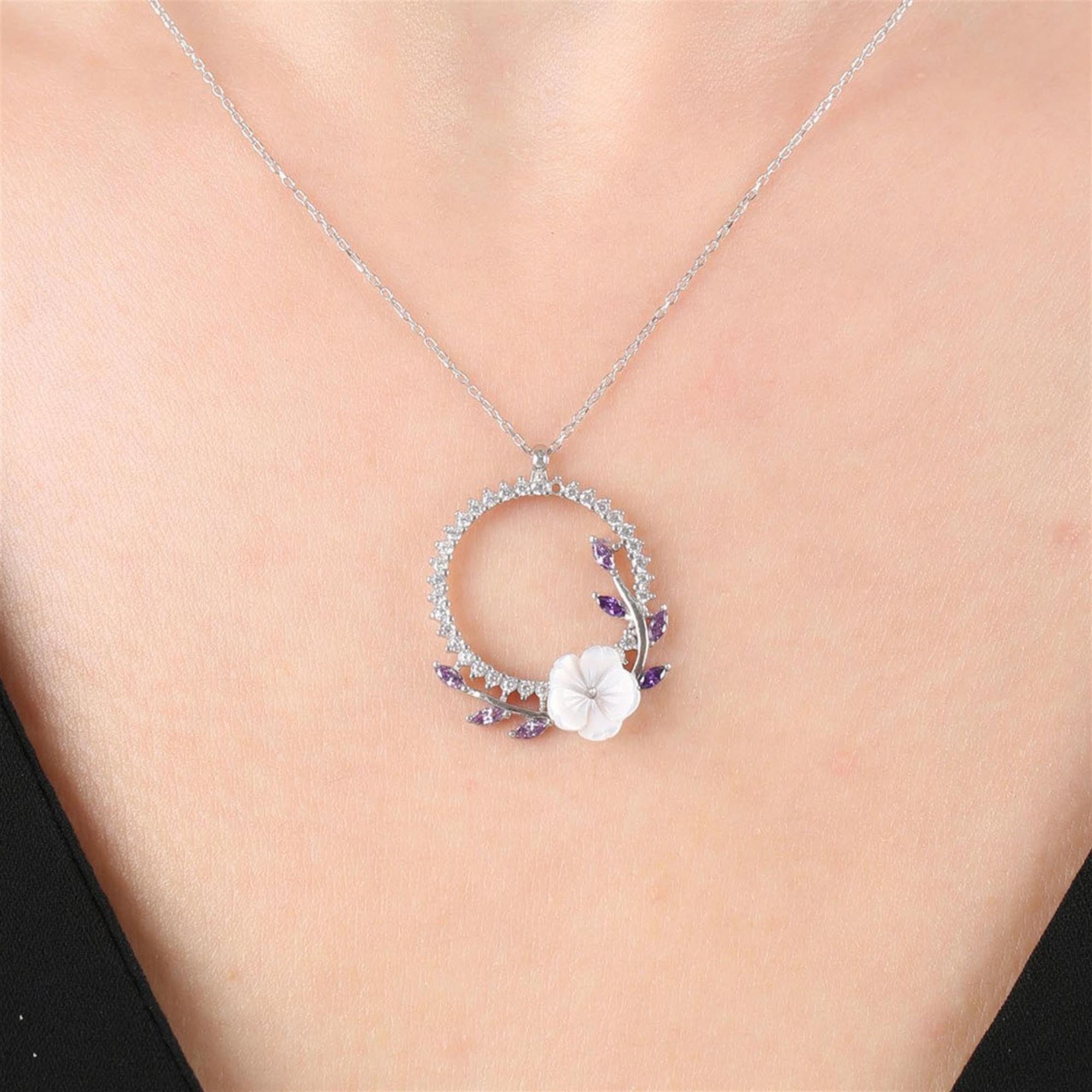 Silver-tone circle necklace with amethyst stones and magnolia flower detail – elegant floral pendant for women