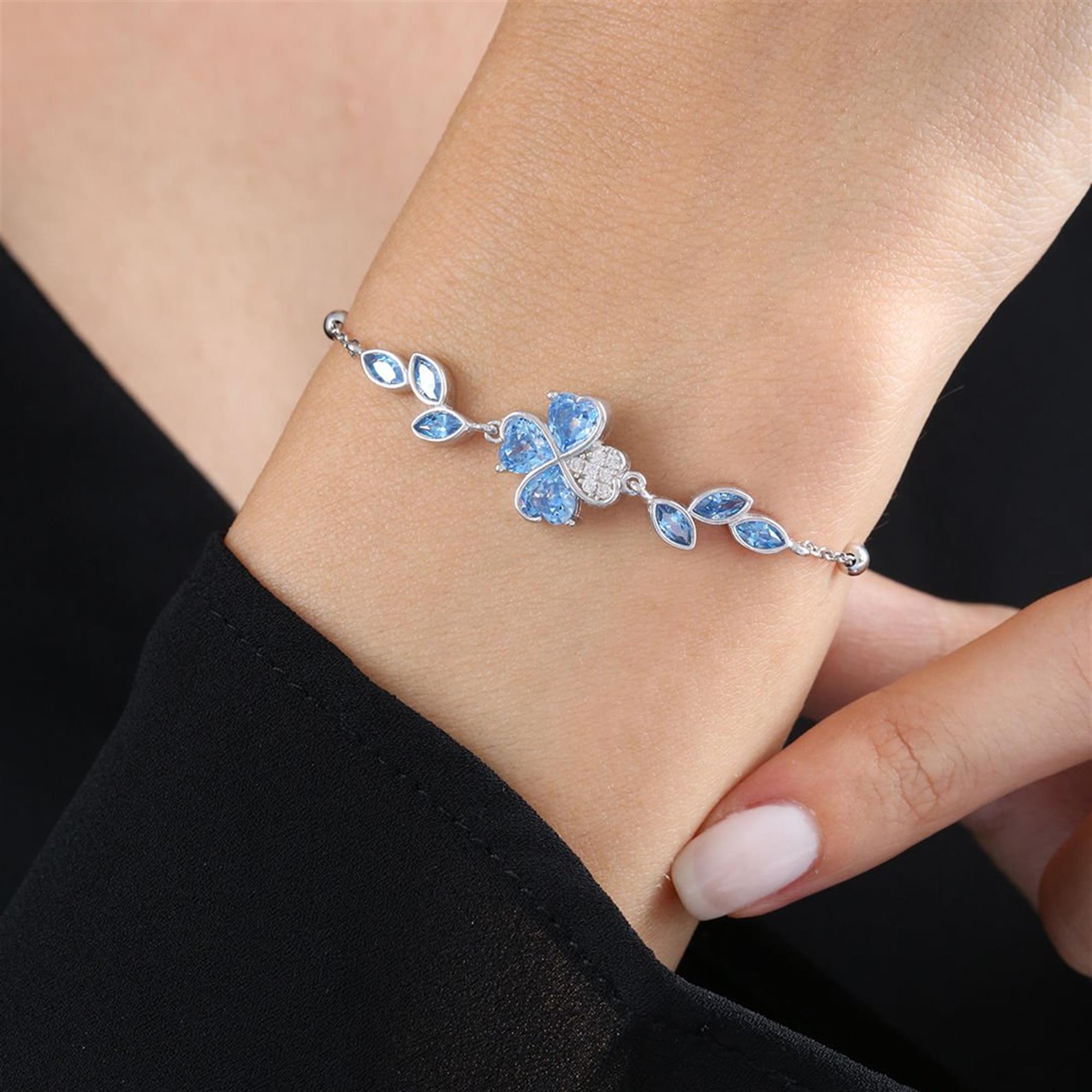 Sterling silver bracelet with aquamarine heart stones forming a clover and leaf-like side gems
