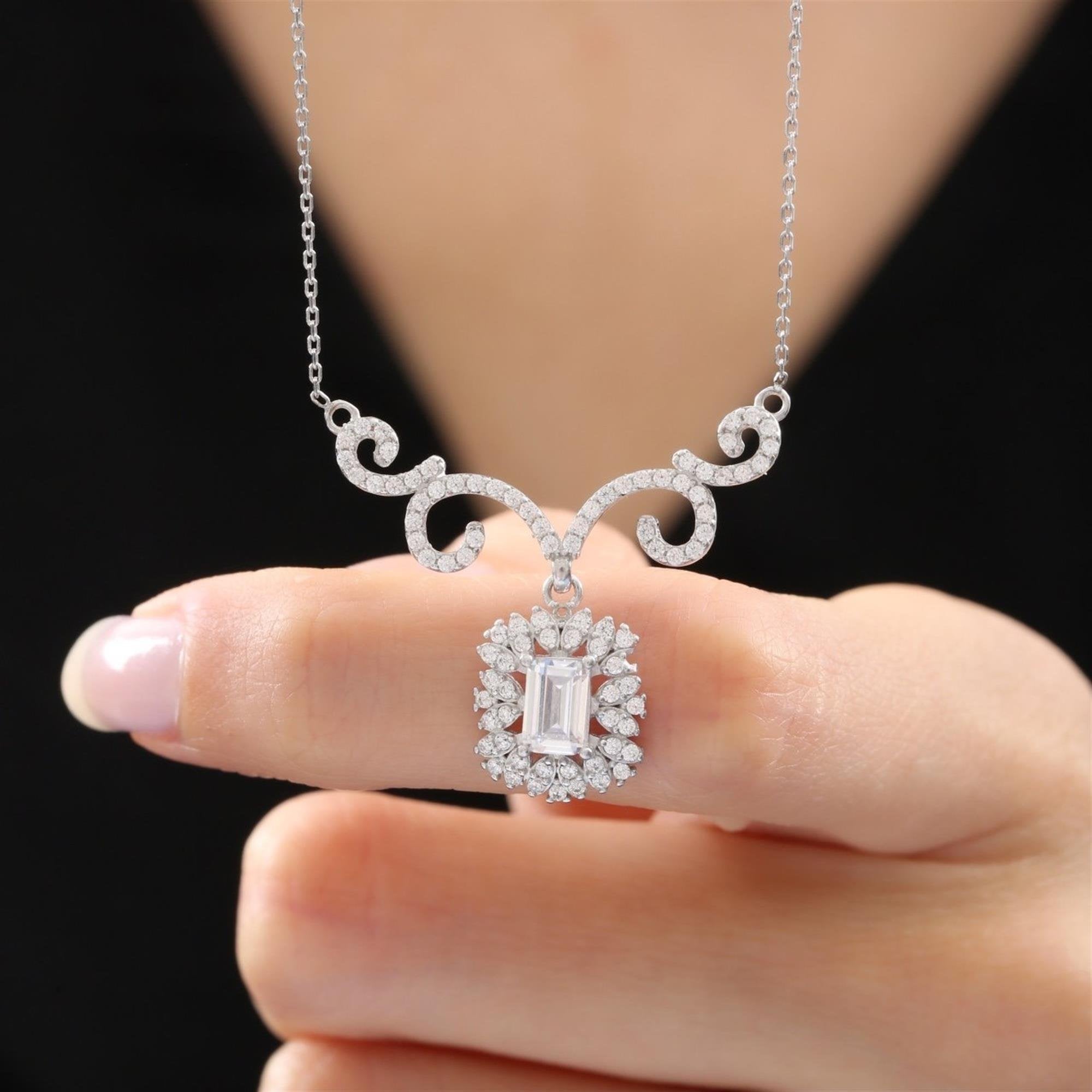 Elegant silver-tone necklace with baguette-cut CZ and vintage swirl accents – perfect formal pendant for women