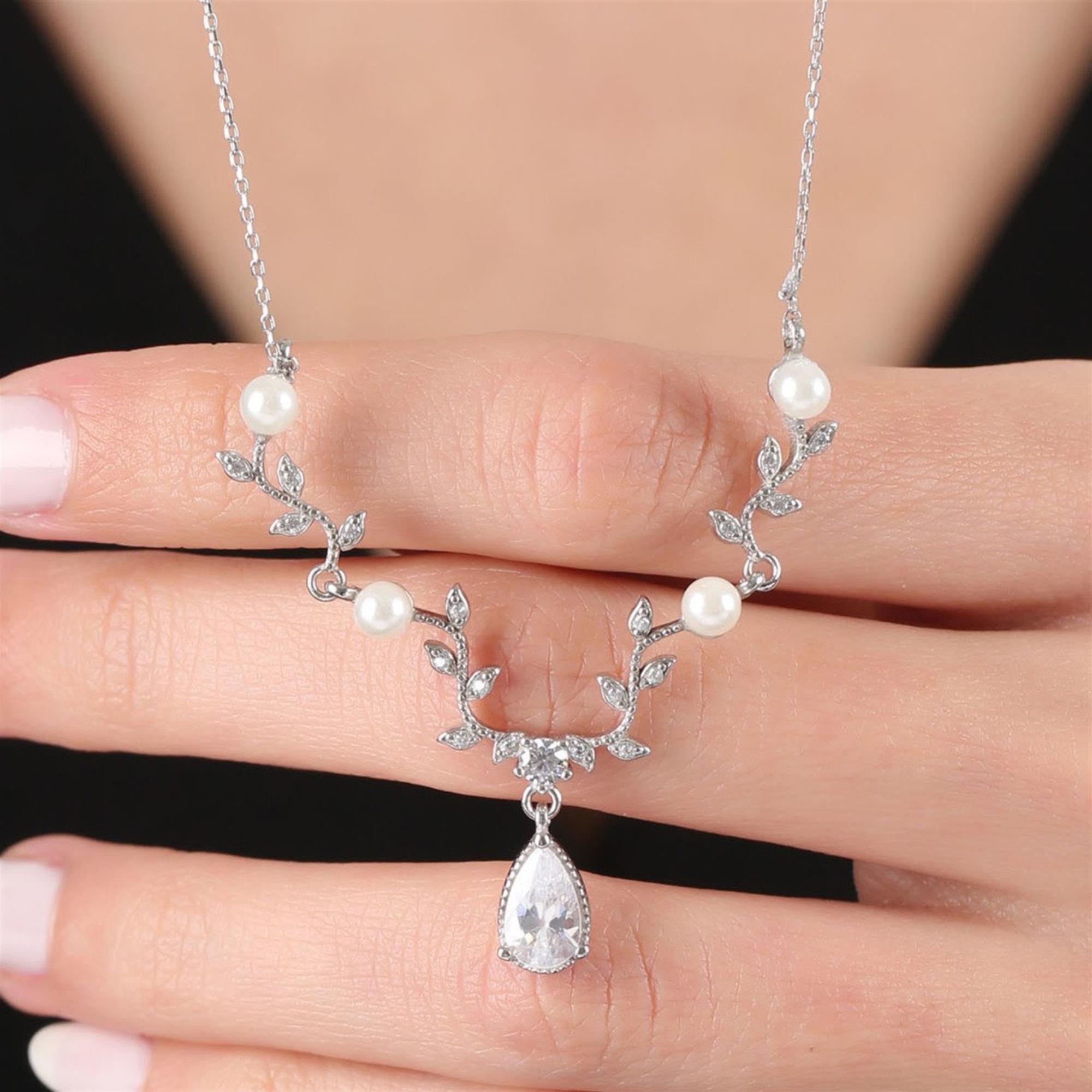 Sterling silver floral necklace with pearl accents and teardrop zirconia – a romantic bridal pendant for timeless elegance.