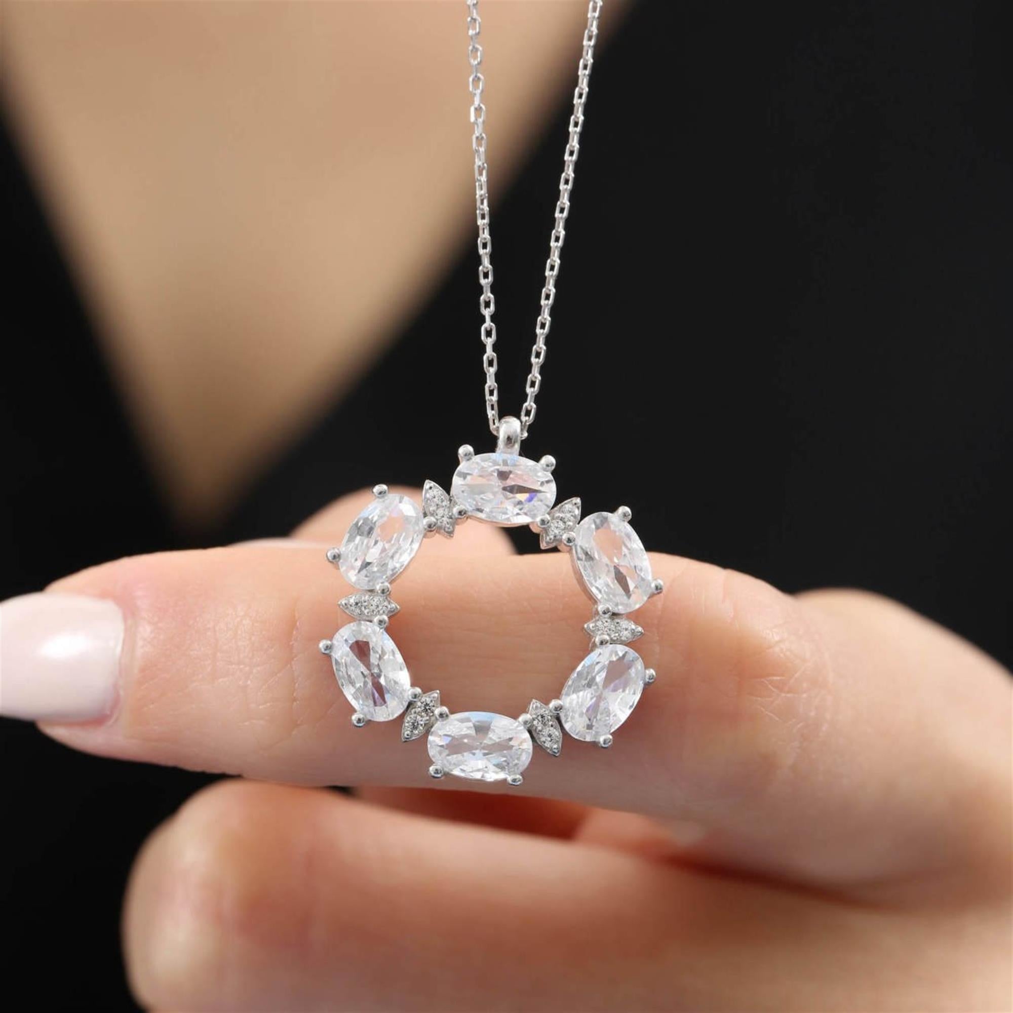 Elegant silver-tone circle necklace with dazzling oval-cut CZ stones – radiant halo pendant for timeless style