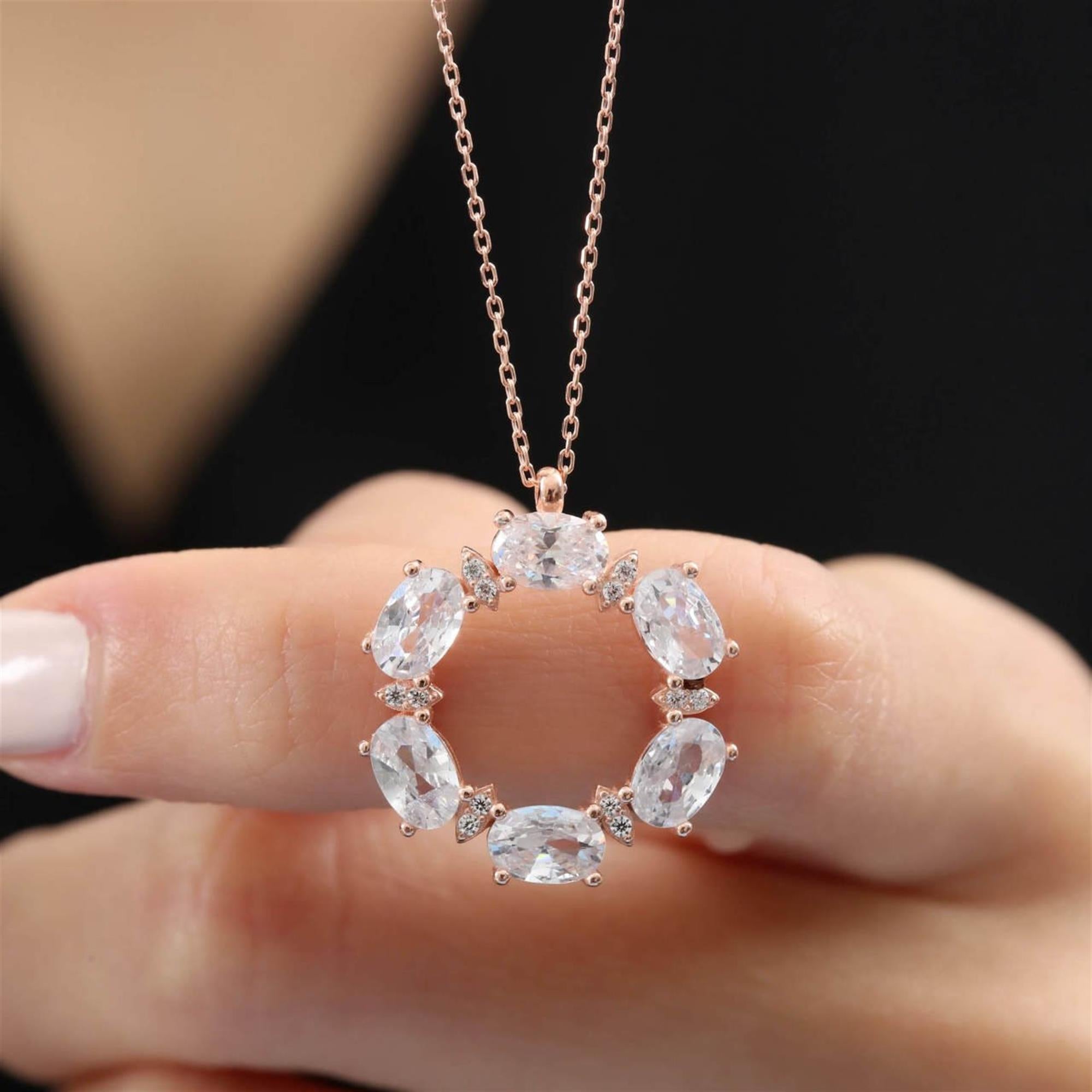 Elegant rose gold circle necklace with dazzling oval-cut CZ stones – radiant halo pendant for timeless style