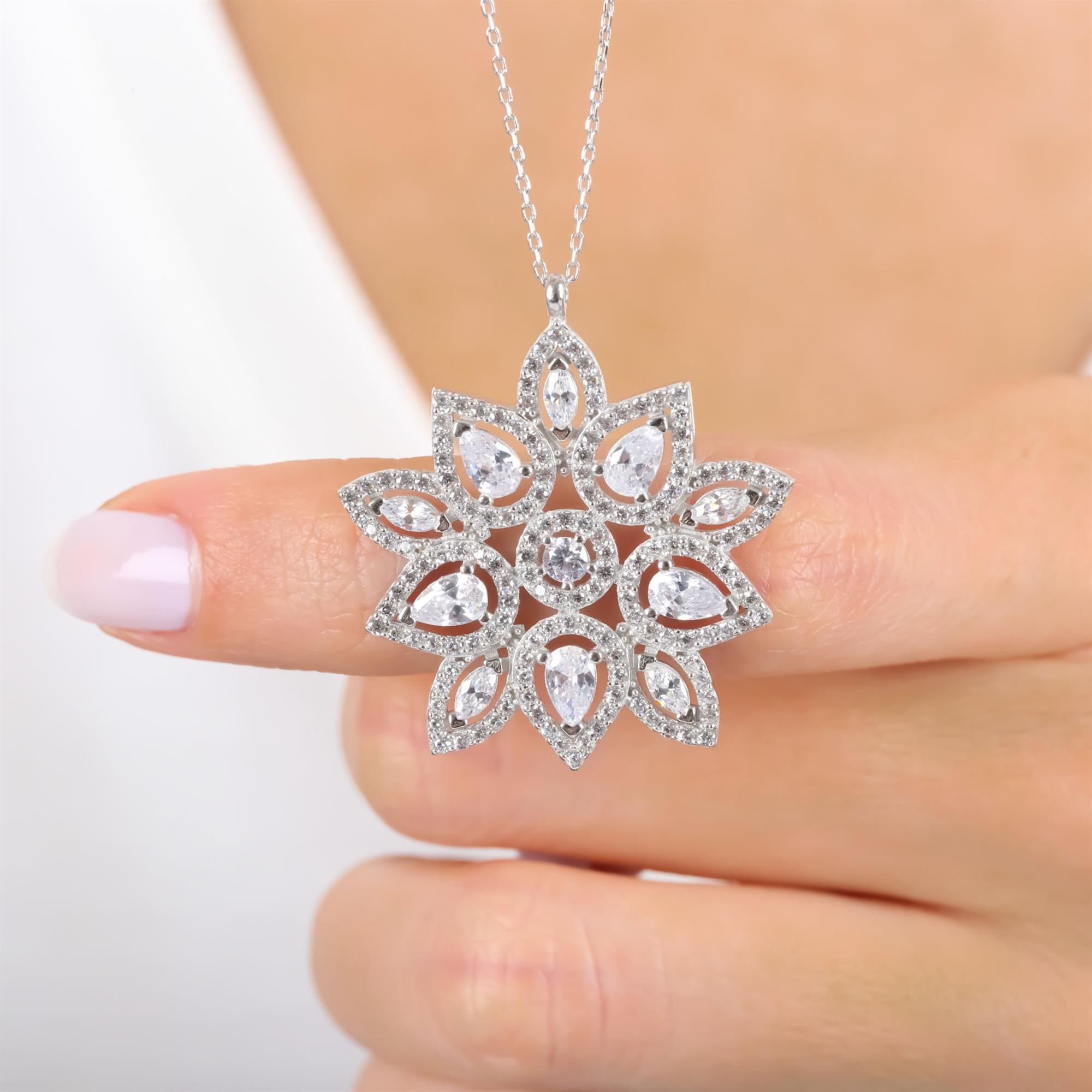 Sterling silver floral starburst pendant necklace with teardrop and round CZ stones