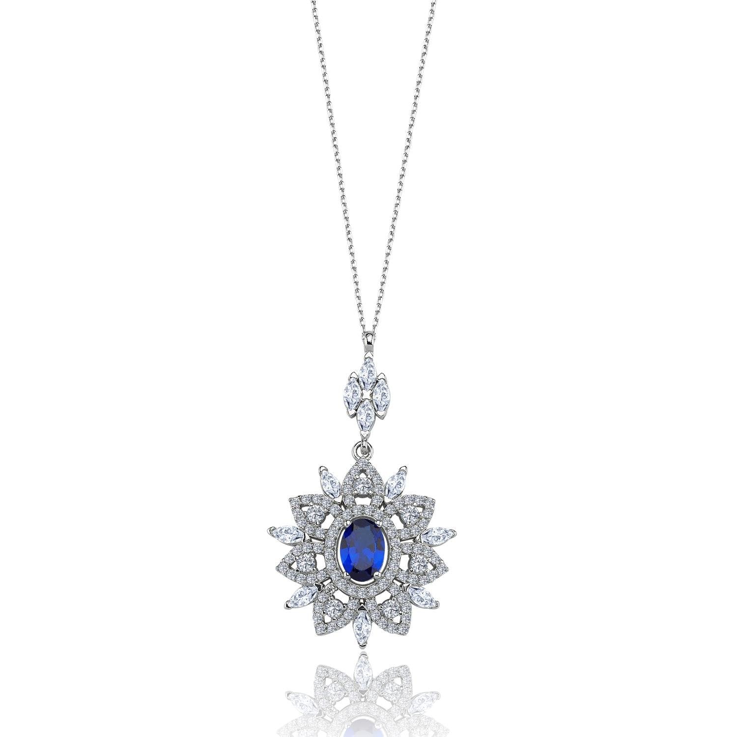 Sterling silver royal pendant necklace with oval-cut sapphire and floral CZ halo – elegant crown-inspired jewelry for women