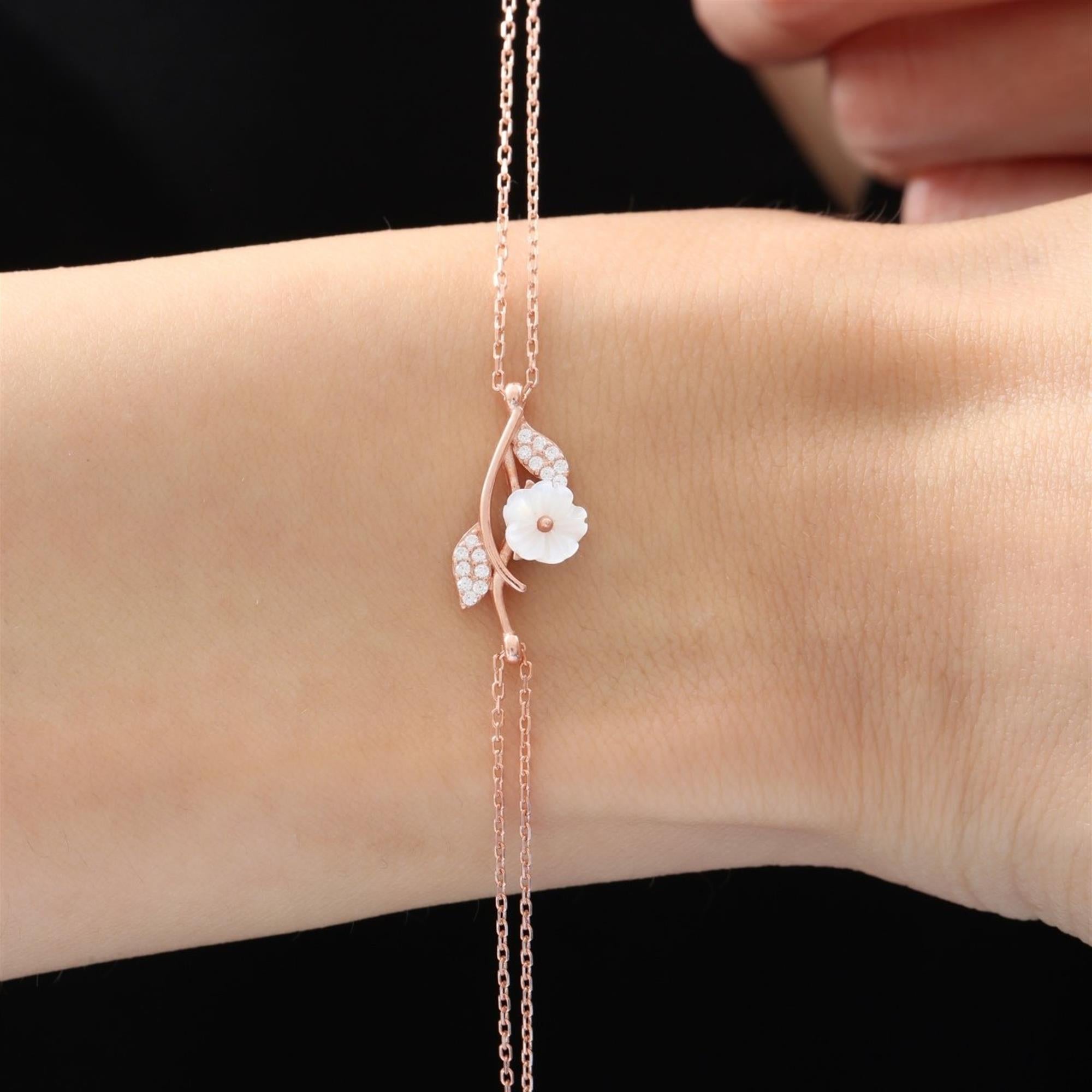 Elegant rose gold bracelet with mother-of-pearl magnolia and cubic zirconia leaf details – nature-inspired botanical wrist jewelry