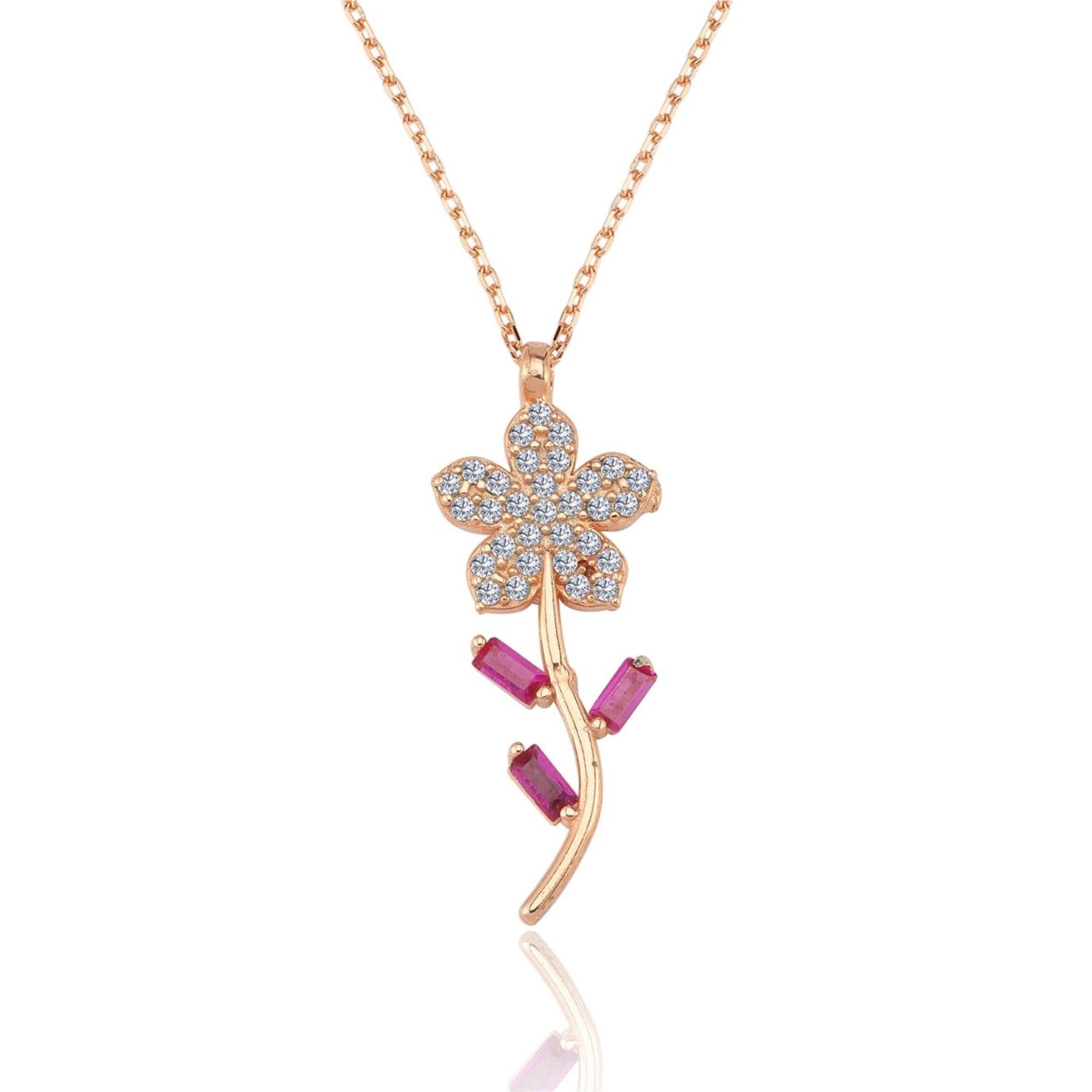 Roségoldene Halskette mit funkelnder Schneeglöckchenblume und lebendigen fuchsiafarbenen Baguette-Steinen.