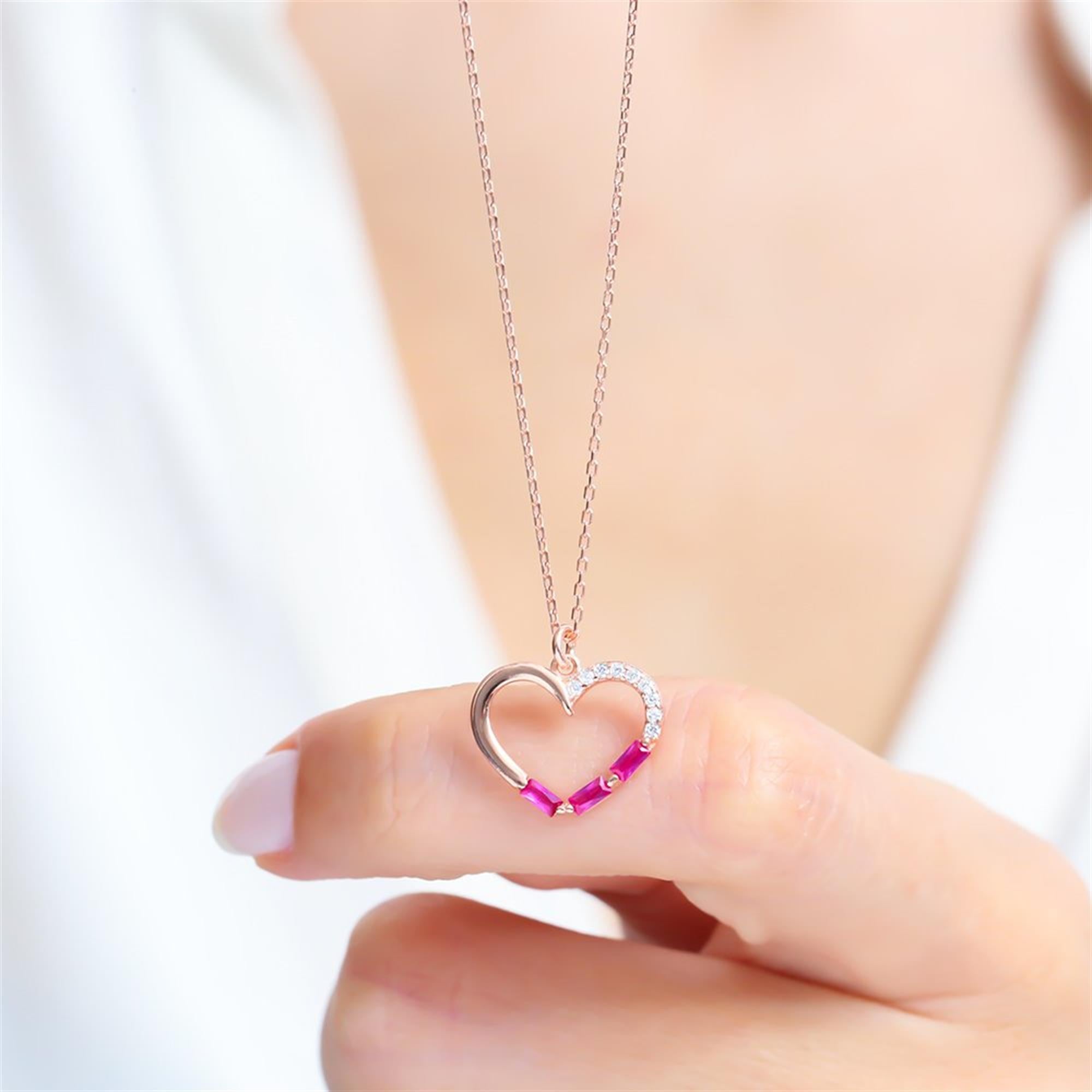 Rose gold open heart necklace with sparkling fuchsia baguette stones and white zirconia accents, a romantic modern gift.