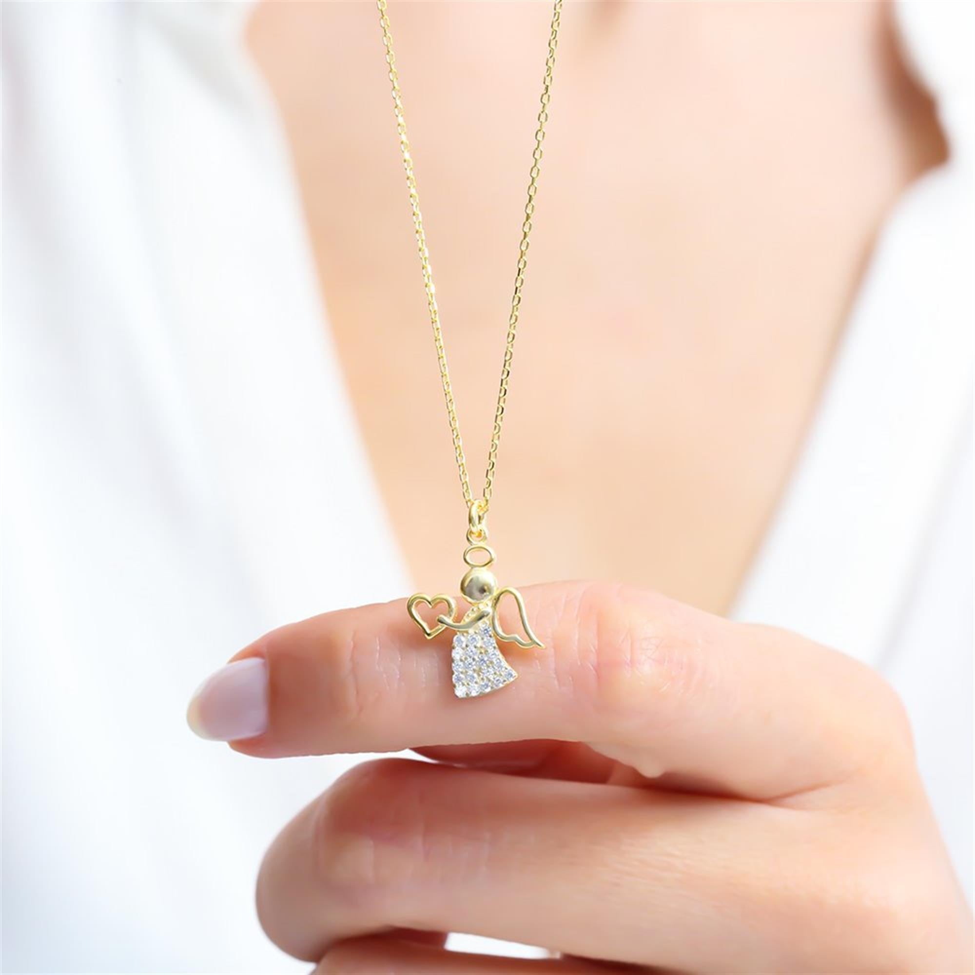 Dainty gold plated angel necklace with heart and zircon skirt – a meaningful gift of love and protection.
