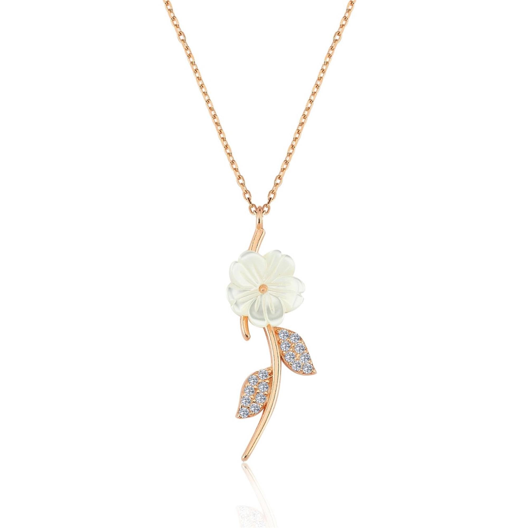 Rose gold necklace with white flower and two sparkling leaves on a slender stem