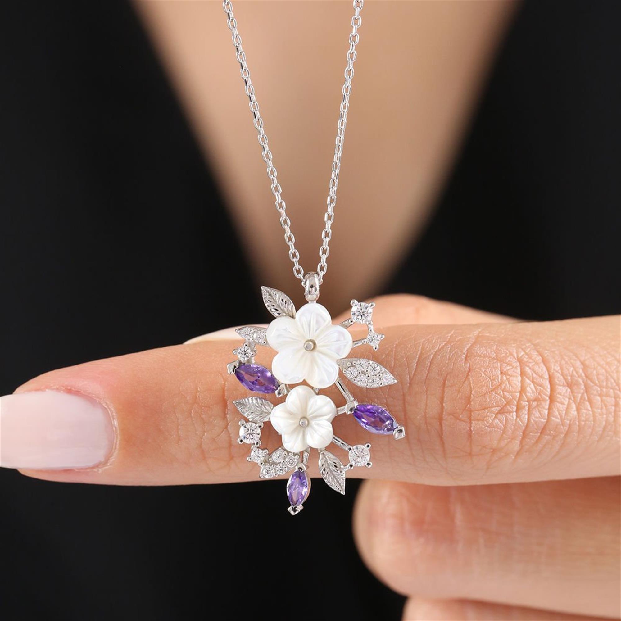 Silver-tone floral necklace with white magnolia flowers, purple CZ stones, and sparkling leaves – spring pendant for women