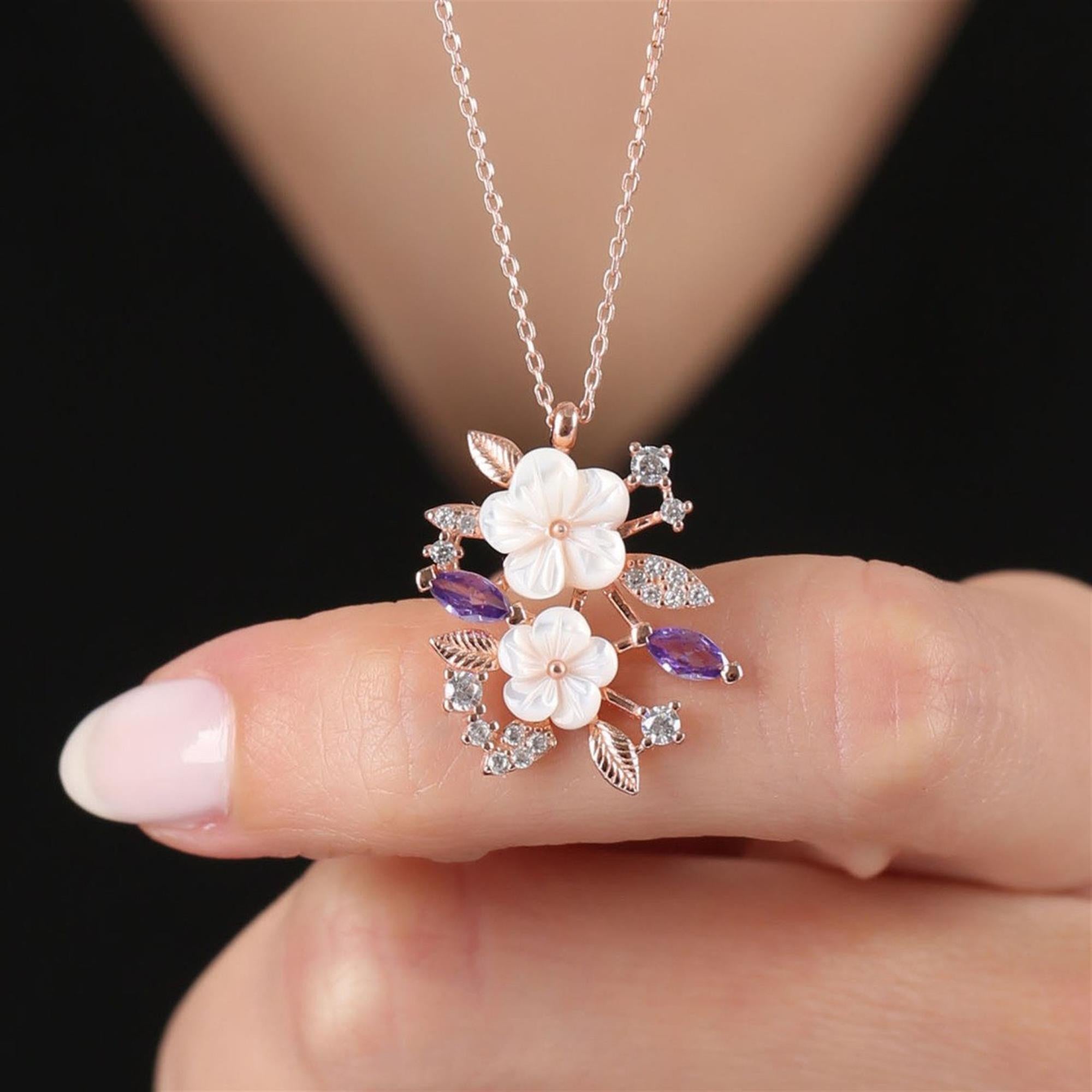 Silver-tone floral necklace with white magnolia flowers, purple CZ stones, and sparkling leaves – spring pendant for women