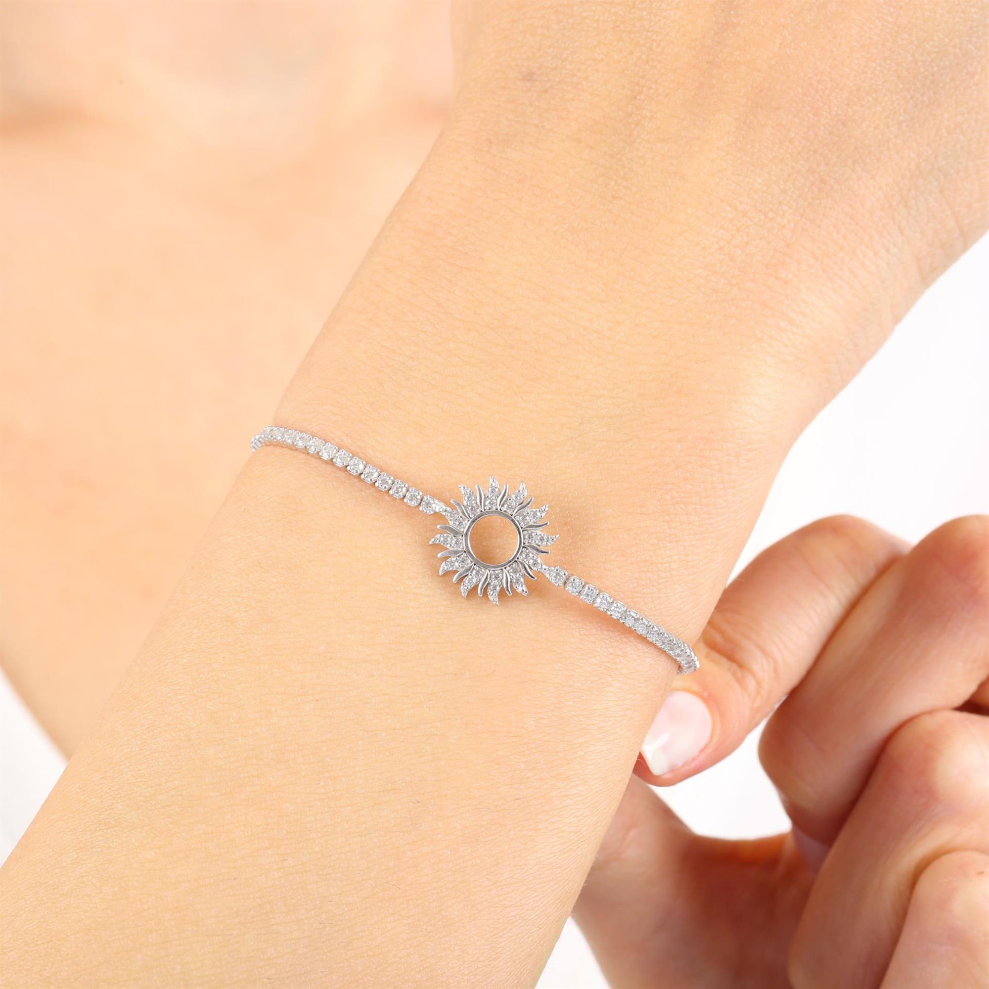 Sterling silver tennis bracelet featuring a radiant sunburst charm with sparkling CZ stones – elegant gift jewelry for women