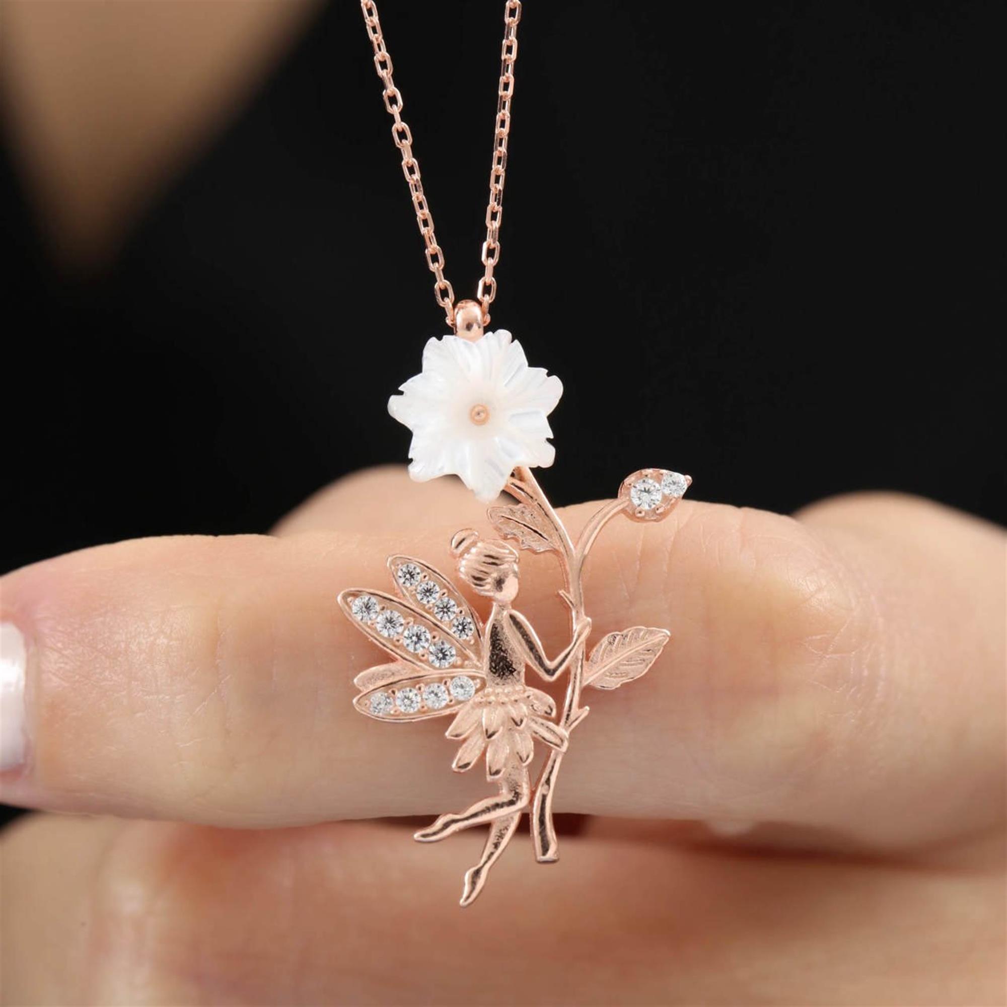 Rose gold fairy necklace holding magnolia flower – whimsical pendant with CZ crystal wings
