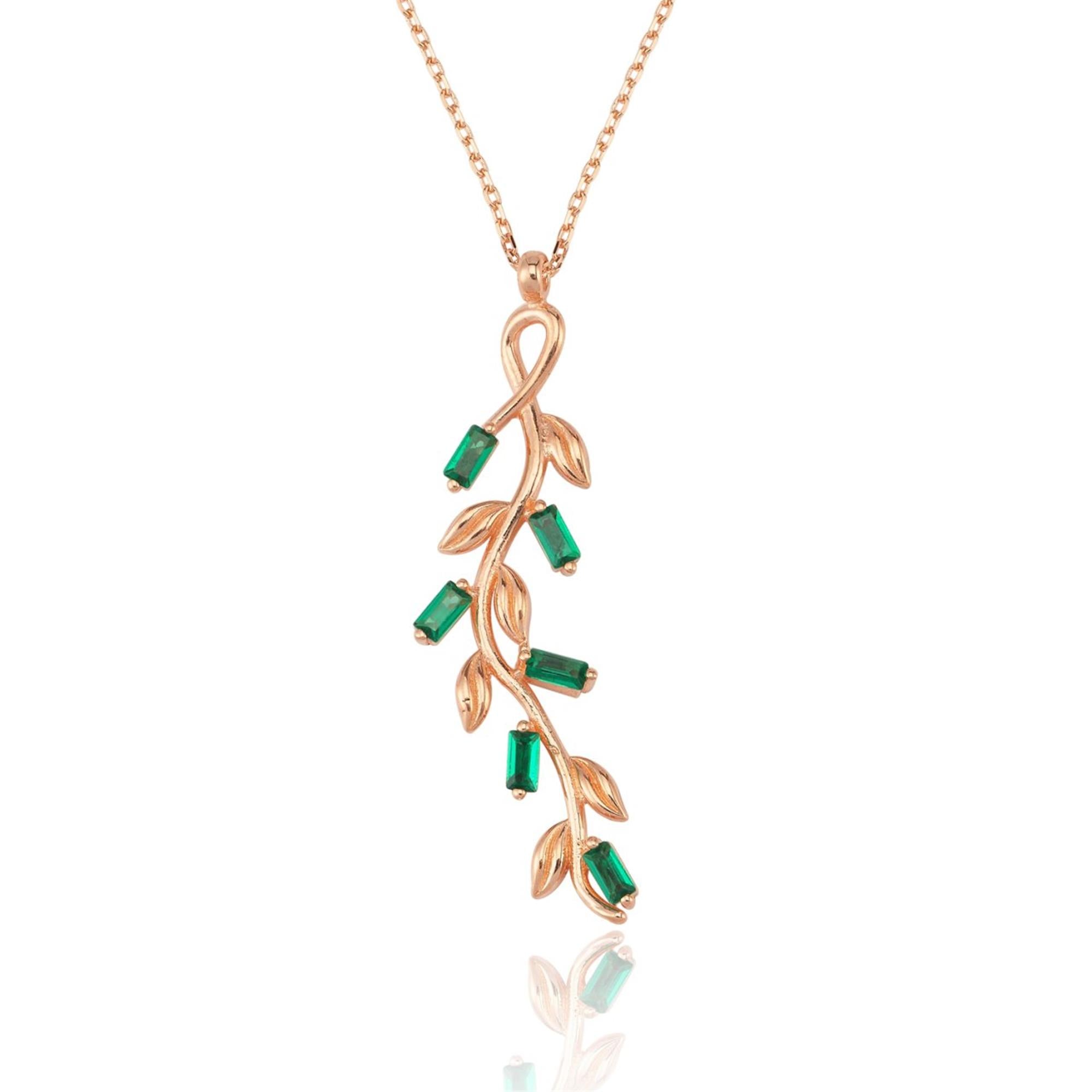 Rose gold olive branch necklace with green baguette stones and detailed leaf design, inspired by nature.