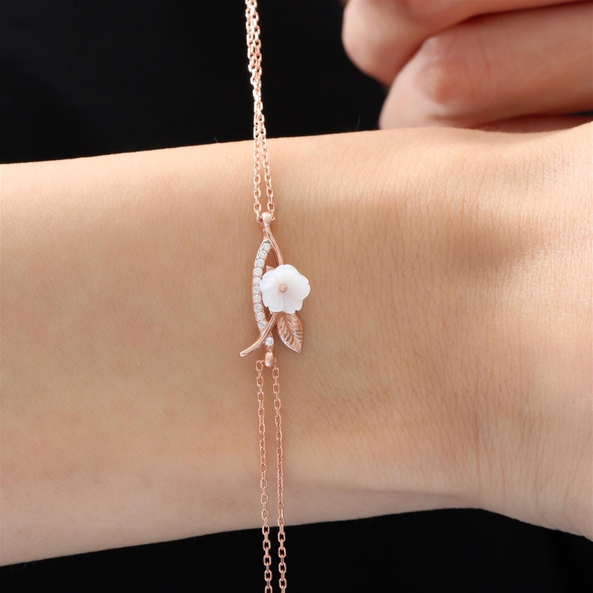 Rose gold magnolia flower bracelet with mother-of-pearl bloom and cubic zirconia leaves – dainty feminine botanical accessory